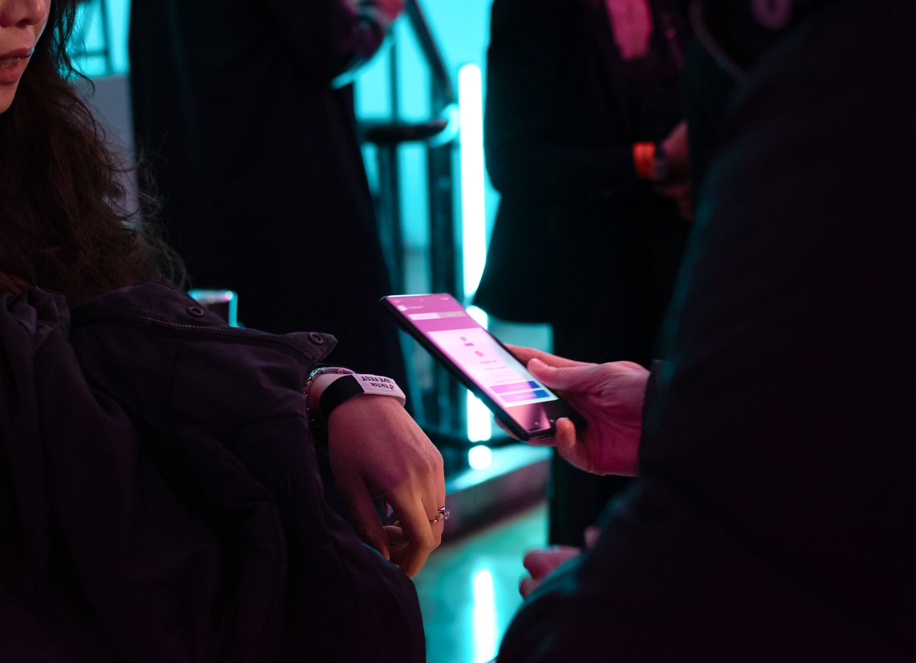 Attendee tapping an RFID wristband at an event